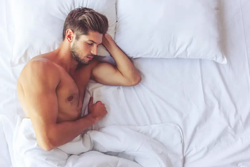 Man sleeping comfortably on cool bamboo sheets